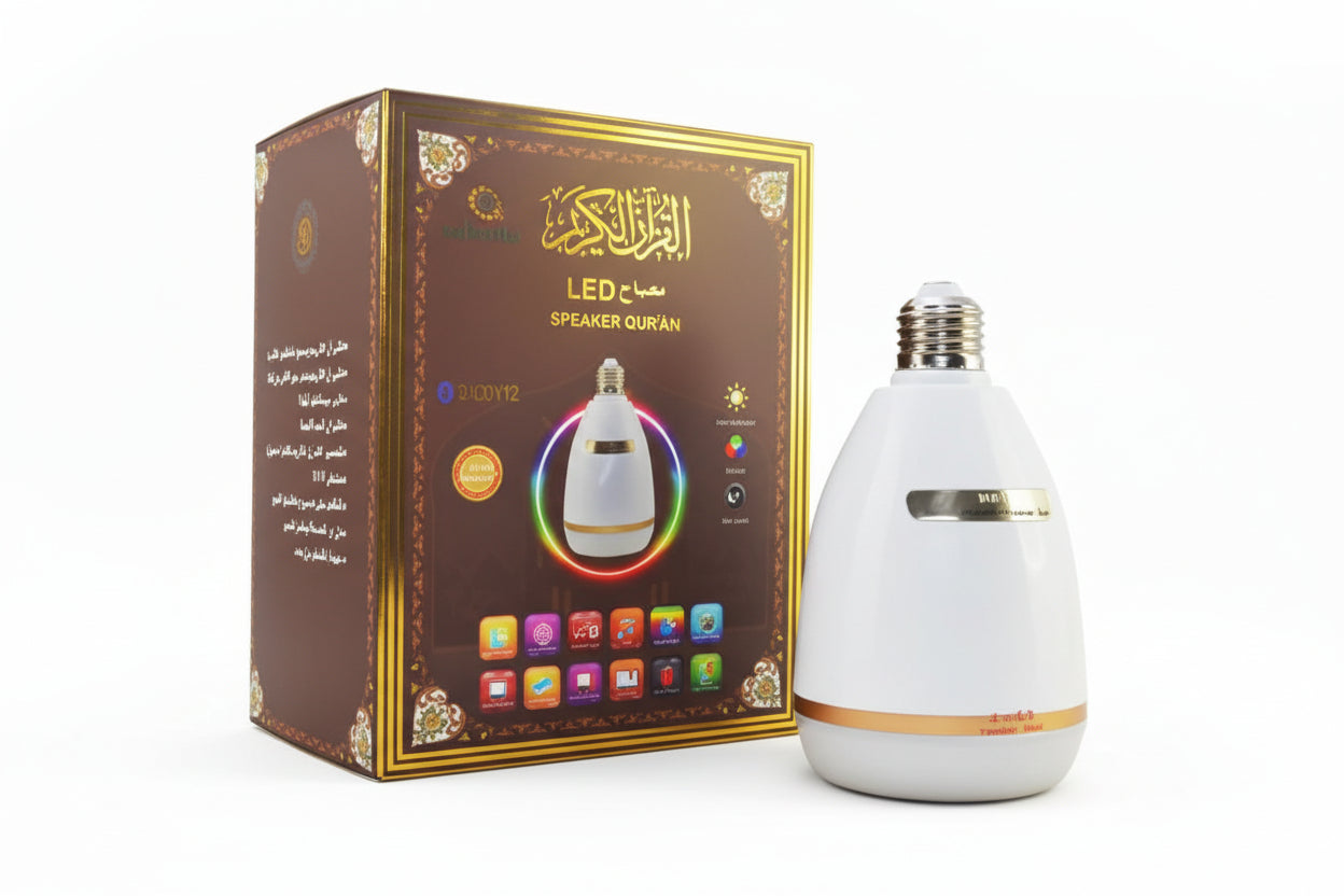 A white cylindrical speaker with multicolored light rings on top, displayed next to its packaging box which has Arabic text and decorative elements.